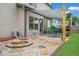 Beautiful backyard patio area with a cozy fire pit and outdoor grilling space at 2470 Day Break Way, Dacula, GA 30019