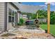 Outdoor patio with shade sail, comfortable seating, and a fire pit at 2470 Day Break Way, Dacula, GA 30019
