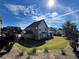 Beautiful backyard with lush green lawn and trees, fenced-in perimeter, and a covered patio at 2506 Monta Vista Way, Hoschton, GA 30548