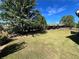 Lush green backyard with an abundance of large trees providing plenty of shade at 2506 Monta Vista Way, Hoschton, GA 30548