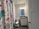 Colorful bathroom with vanity, toilet, and shower featuring a cheerful unicorn-themed curtain at 2506 Monta Vista Way, Hoschton, GA 30548