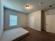 Clean bedroom with carpet, a window with blinds, and paneled doors at 2506 Monta Vista Way, Hoschton, GA 30548