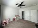 Bright bedroom with a ceiling fan, ample space for play, and a view of an adjacent bathroom at 2506 Monta Vista Way, Hoschton, GA 30548