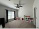 Cozy ' bedroom with natural light, decorated with a ceiling fan, and space for play and storage at 2506 Monta Vista Way, Hoschton, GA 30548
