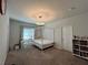 Bedroom featuring a four-poster bed, desk area, and a bookshelf for a comfortable living space at 2506 Monta Vista Way, Hoschton, GA 30548