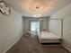 Comfortable bedroom featuring a four-poster bed, desk area, and ample natural light at 2506 Monta Vista Way, Hoschton, GA 30548