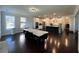 View of the open concept dining and kitchen area with dark hardwood floors at 2506 Monta Vista Way, Hoschton, GA 30548