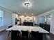 Dining room with large table, modern lighting, and open to kitchen for entertaining at 2506 Monta Vista Way, Hoschton, GA 30548
