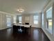 Bright dining room with a large table, fireplace, ample windows, and hardwood floors throughout at 2506 Monta Vista Way, Hoschton, GA 30548