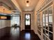 Inviting foyer boasts hardwood floors, coffered ceiling, dark wood door and a pendant light at 2506 Monta Vista Way, Hoschton, GA 30548