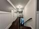 Bright hallway featuring dark wood floors and wainscoting leading to the stairwell at 2506 Monta Vista Way, Hoschton, GA 30548