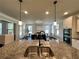 Kitchen with granite countertop, double sink, pendant lights, and a view into the dining area and living room at 2506 Monta Vista Way, Hoschton, GA 30548