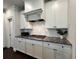 Modern kitchen featuring white cabinets, granite countertops, and a white subway tile backsplash, great for cooking at 2506 Monta Vista Way, Hoschton, GA 30548