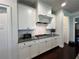 Well-lit kitchen with white cabinets, granite countertop, and a white subway tile backsplash, great for cooking at 2506 Monta Vista Way, Hoschton, GA 30548