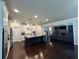 Spacious kitchen with granite island, stainless appliances, and open floor plan into the adjacent living room at 2506 Monta Vista Way, Hoschton, GA 30548