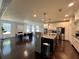 Open concept kitchen with island seating, stainless appliances, and plenty of space for cooking and entertaining at 2506 Monta Vista Way, Hoschton, GA 30548