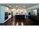 Spacious kitchen with granite countertops, an island with seating, and stainless steel appliances connected to the living area at 2506 Monta Vista Way, Hoschton, GA 30548