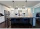 Modern kitchen island with granite countertop and seating, complemented by stainless steel appliances and white cabinets at 2506 Monta Vista Way, Hoschton, GA 30548