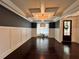Spacious living room boasts hardwood floors, coffered ceiling and modern light fixture at 2506 Monta Vista Way, Hoschton, GA 30548