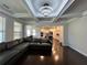 Open living room showcasing coffered ceilings, hardwood floors, and modern furnishings at 2506 Monta Vista Way, Hoschton, GA 30548