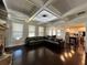 Open concept living room showcasing coffered ceiling and seamless flow to kitchen at 2506 Monta Vista Way, Hoschton, GA 30548