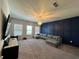Living room with dark blue accent wall, large windows and recessed lighting at 2506 Monta Vista Way, Hoschton, GA 30548