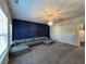 Bright living room showcasing a dark blue accent wall, recessed lights and carpet at 2506 Monta Vista Way, Hoschton, GA 30548