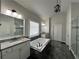 Luxurious main bathroom featuring granite countertops, modern fixtures and sleek tile at 2506 Monta Vista Way, Hoschton, GA 30548