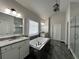 Luxurious main bathroom featuring granite countertops, modern fixtures and sleek tile at 2506 Monta Vista Way, Hoschton, GA 30548