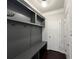 Gray mudroom features a built-in bench, storage and hooks for organization at 2506 Monta Vista Way, Hoschton, GA 30548