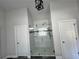 Modern shower with glass door and neutral colored tile and decorative accent border at 2506 Monta Vista Way, Hoschton, GA 30548