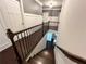 Dark wood staircase with sleek wrought iron railing, connecting multiple floors in the house at 2506 Monta Vista Way, Hoschton, GA 30548