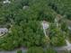 Aerial view of a house nestled amongst trees, with a long driveway at 2700 Sam Nelson Rd, Canton, GA 30114
