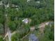 Aerial view of a neighborhood with tree lined streets and lush green trees at 2700 Sam Nelson Rd, Canton, GA 30114