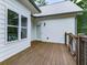 A charming wood back porch with white siding and windows gives a serene view at 2700 Sam Nelson Rd, Canton, GA 30114
