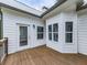 A charming wood back porch with white siding and windows gives a serene view at 2700 Sam Nelson Rd, Canton, GA 30114