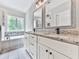 Bathroom featuring double vanities, granite countertops, and a soaking tub at 2700 Sam Nelson Rd, Canton, GA 30114