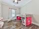 Charming bedroom with wood floors features a playful bunk bed with slide and a large window at 2700 Sam Nelson Rd, Canton, GA 30114