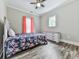 Cozy bedroom with wood-look floors has a floral comforter, natural light, and matching dresser at 2700 Sam Nelson Rd, Canton, GA 30114