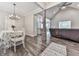 Cozy dining area with chandelier, table set for four, seamlessly connected to the living spaces at 2700 Sam Nelson Rd, Canton, GA 30114