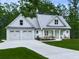 Charming exterior of a two-story home with a two-car garage and a inviting front porch at 2700 Sam Nelson Rd, Canton, GA 30114