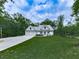 Stunning home exterior featuring a lush green lawn, two-car garage and inviting front porch at 2700 Sam Nelson Rd, Canton, GA 30114