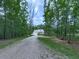 Charming home with a long gravel driveway and inviting front porch at 2700 Sam Nelson Rd, Canton, GA 30114