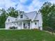 Beautiful home exterior with a two-car garage and charming front porch rocking chairs at 2700 Sam Nelson Rd, Canton, GA 30114