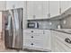 Kitchen features white cabinets, stainless steel appliances, and granite countertops at 2700 Sam Nelson Rd, Canton, GA 30114