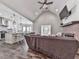 Open concept living area with vaulted ceiling, fireplace, and seamless transition to the modern kitchen at 2700 Sam Nelson Rd, Canton, GA 30114