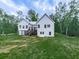 A modern two-story home with a rear porch, white siding, and lush green lawn at 2700 Sam Nelson Rd, Canton, GA 30114