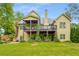 Large backyard with a covered deck, patio and lush landscaping provide shade and privacy at 374 Beaumont Farms Dr, Sharpsburg, GA 30277