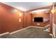 Finished basement features carpet, a large television screen, and access to the staircase at 374 Beaumont Farms Dr, Sharpsburg, GA 30277