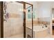 Beautiful bathroom featuring a large shower with glass door and separate soaking tub with tile accents at 374 Beaumont Farms Dr, Sharpsburg, GA 30277